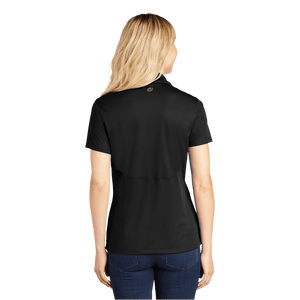 Back of model wearing women's black polo with Insideya Golf icon on back yoke