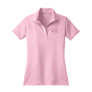 A pink Insideya Golf Sport-Tek women's micropique sport-wick polo shirt with a collar and short sleeves.