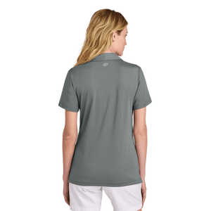 Back of model wearing women's TravisMathew grey polo with Insideya Golf icon on back yoke