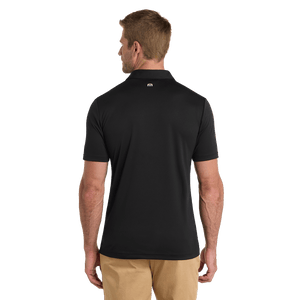 Black TravisMathew Coto Performance Polo with embroidered Insideya Golf logo on left chest back model