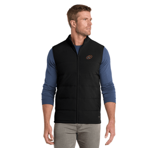 Model wearing black TravisMathew vest with Insideya Golf icon on left chest