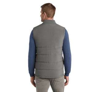 Back of model wearing grey TravisMathew vest