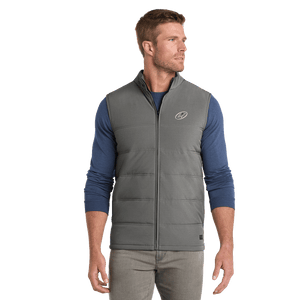 Model wearing grey TravisMathew vest with Insideya Golf icon on left chest